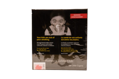 A single Romeo y Julieta Club cigarillo with a natural wrapper, placed on a wooden surface.