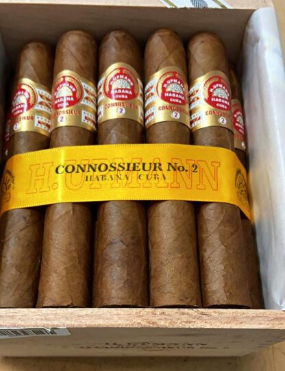 A luxurious wooden box of H. Upmann Connoisseurs No. 2 cigars, neatly arranged with each cigar showcasing its signature Cuban craftsmanship. The box features the iconic H. Upmann branding, with a golden seal and elegant presentation, emphasizing its premium quality.