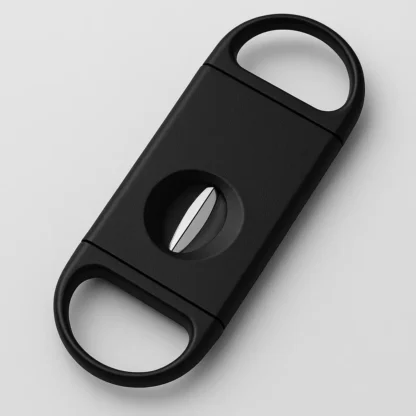 Black Grab A Leaf V-cut cigar cutter displayed diagonally on a light gray background, featuring ergonomic finger grips and a sharp stainless steel V-blade.