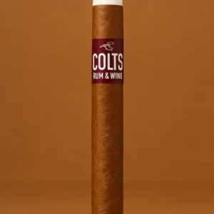 Single Colts Rum & Wine cigar with white tip, upright on a warm brown studio background.