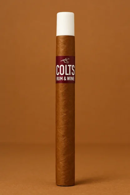 Single Colts Rum & Wine cigar with white tip, upright on a warm brown studio background.