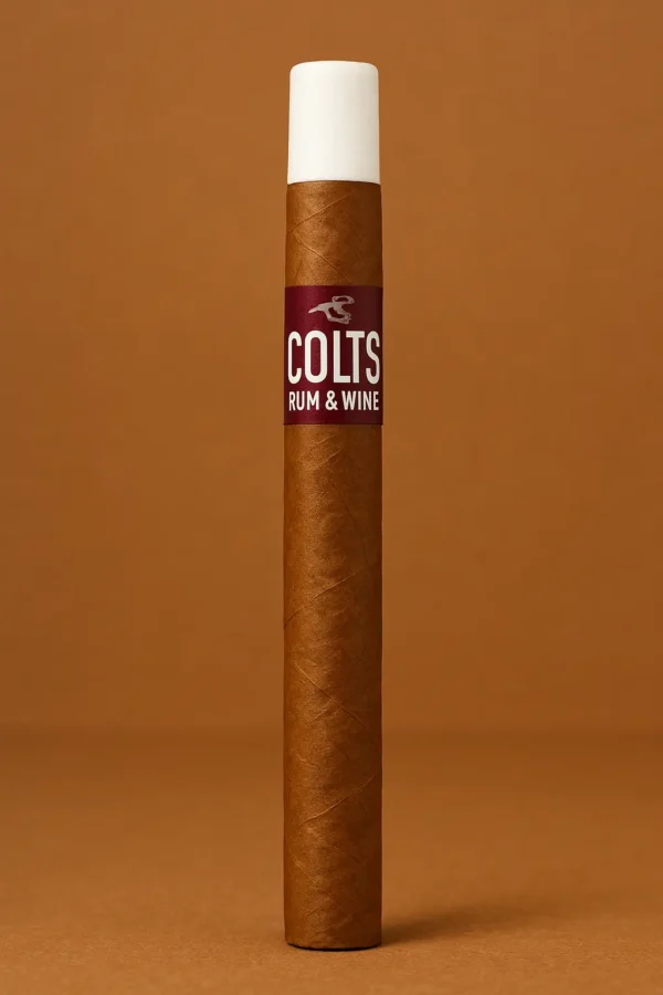 Single Colts Rum & Wine cigar with white tip, upright on a warm brown studio background.