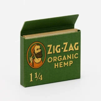 Zig-Zag Organic Hemp 1 1/4 rolling papers in a green pack with open flap, showing natural paper sheets inside.
