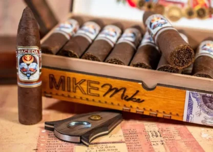 Close-up of Maceda Mike-Mike 5 Pack cigars in a branded wooden box with cigar cutter.